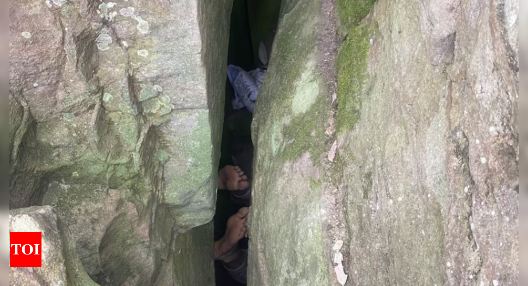 Australian woman wedged upside down between boulders for seven hours after trying to retrieve phone – Times of India