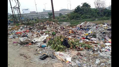 This road to NH-9 is now a dumpsite, trucks unload trash here