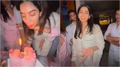 Khushi Kapoor's rumoured boyfriend Vedang Raina gently holds her hair back affectionately as she blows out birthday candles