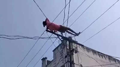 Watch: Drunk man climbs electric pole, lies on electric wires over denied money for liquor in Andhra Pradesh's Manyam district