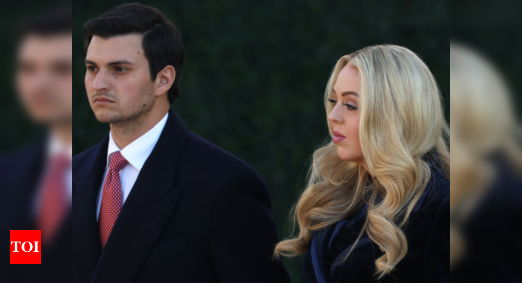 Tiffany Trump wraps herself in a navy blue floor-length coat dress for Trump's inauguration