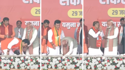 PM Modi stops BJP candidate from touching his feet, instead touches young leader's feet 3 times at Delhi rally