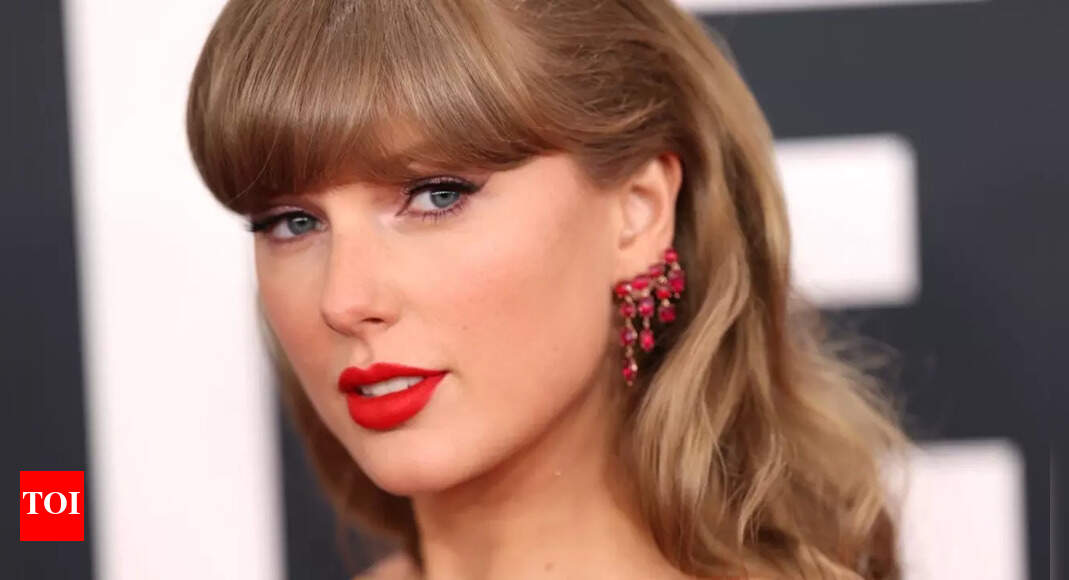 Taylor Swift slips into a silver embellished mini dress for Grammys