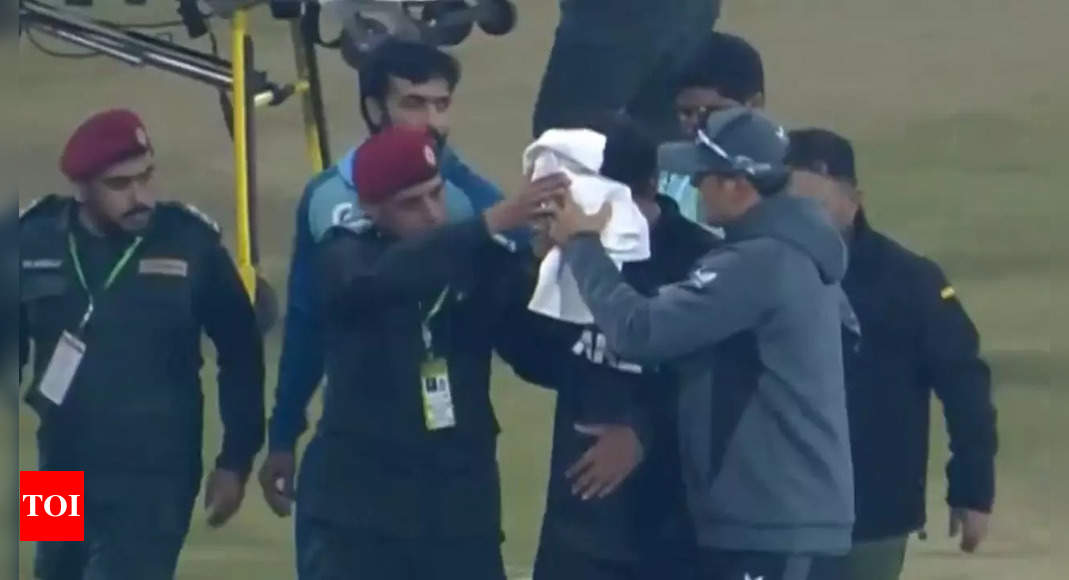 Bloody! Face covered with towel, Rachin Ravindra carried off the field against Pakistan – Watch | Cricket News – The Times of India