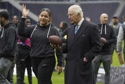 King Charles gets a quarterback lesson while celebrating NFL charity work at Tottenham Hotspur stadium