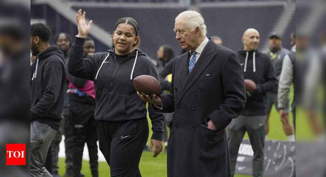 King Charles gets a quarterback lesson while celebrating NFL charity work