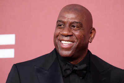 NBA veteran Magic Johnson applauds Michigan State coach Tom Izzo after his legendary 354th win