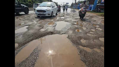 Commuters, patients struggle to cross potholed, drain water-filled road