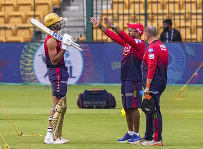 Royal Challengers Bengaluru's Devdutt Padikkal with team mentor Dinesh Karthik and team head coach Andy Flower during a practice session ahead of the Indian Premier League (IPL) 2025 cricket match against Chennai Super Kings at M Chinnaswamy Stadium in Bengaluru. (PTI) IPL 2025: Will rain play spoilsport in RCB vs CSK blockbuster at M Chinnaswamy Stadium in Bengaluru?