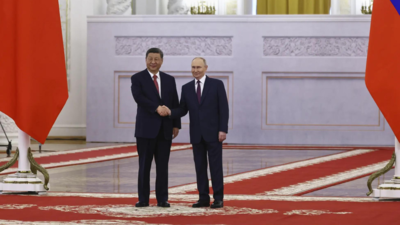 Xi meets Putin in Moscow as Ukraine reports truce violations