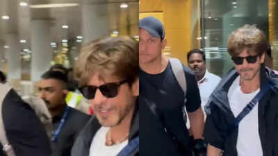Shah Rukh Khan flashes a warm smile at paparazzi as he arrives at Mumbai airport after making Met Gala debut