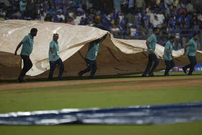 Ground staff bring in covers. (AP Photo) Wankhede Stadium weather: Will rain disrupt crucial MI vs DC IPL 2025 game?