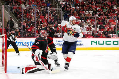Carolina Hurricanes vs Florida Panthers faceoff under stormy sky