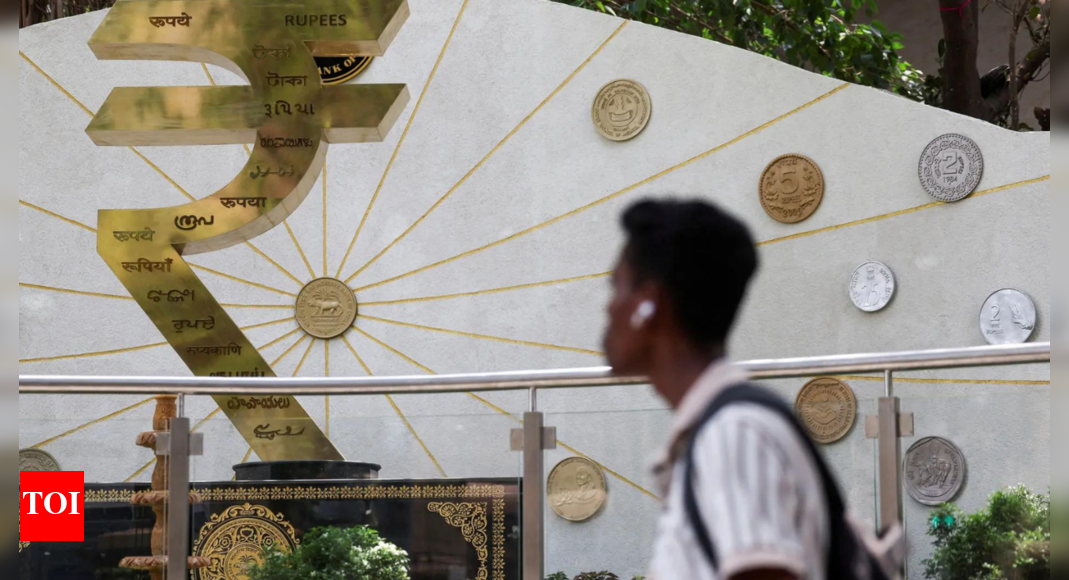 Rupee falls 21 paise to 85.60 against US dollar amid weak equities, FII outflows – Times of India