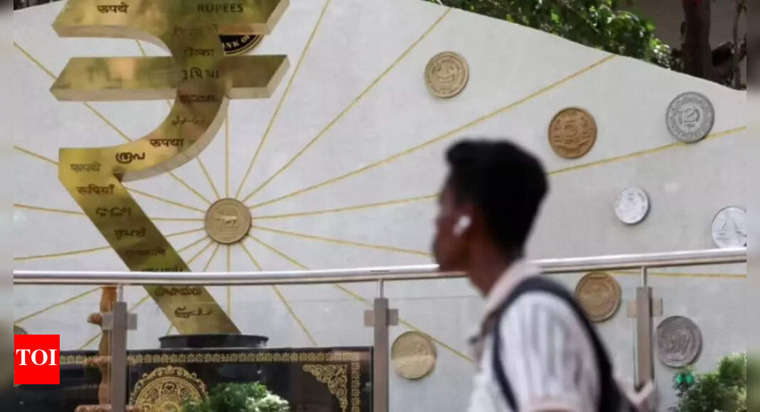 Rupee drops to 85.86 vs dollar amid foreign outflows; RBI rate cut in focus – Times of India