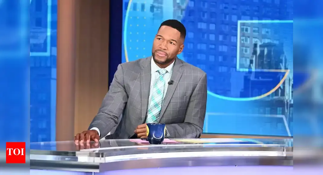 Michael Strahan stands by ESPN host Jay Harris during a heartbreaking announcement that has shocked fans