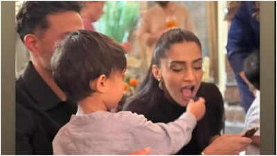  Her heart melts as son Vayu feeds her cake. See photo