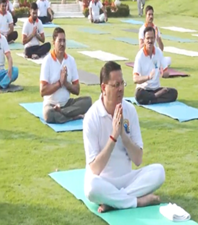 CM Dhami practises yoga ahead of International Yoga Day