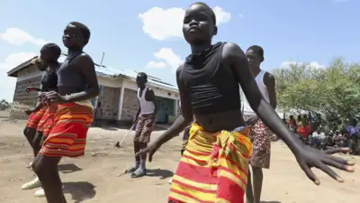 Fusion between culture, modernity as children dance in Kenya's refugee camp