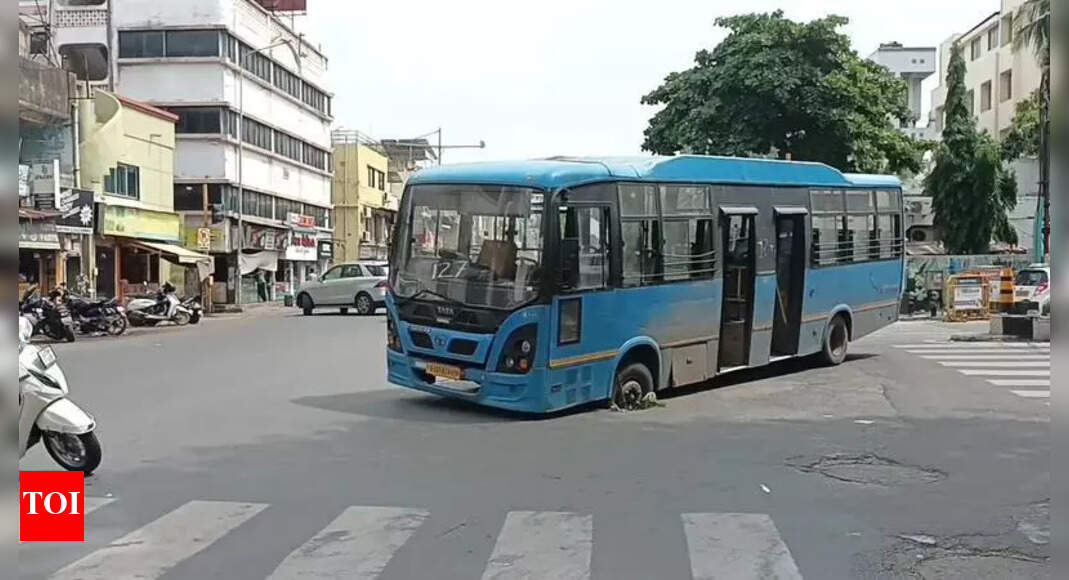 City bus gets stuck in pothole, exposes crumbling roads | Surat News - Times of India
