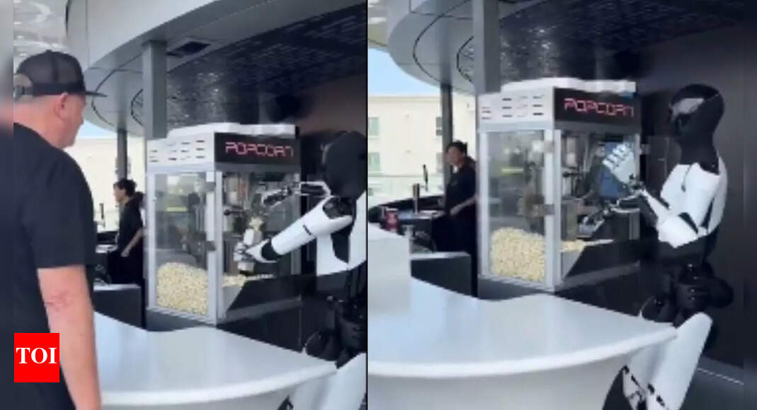 Elon Musk's Tesla Optimus humanoid robot serving popcorn goes ...