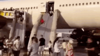 Panic at Turkish Airport: Boeing 777 passengers evacuate via emergency slides after smoke detected — Watch