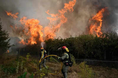 Wildfires in Spain kill one and force thousands to flee