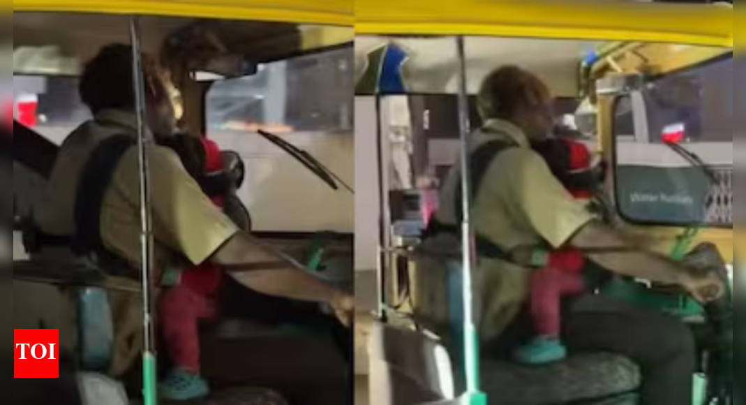 Baby in one arm, wheel in the other: Auto driver cradles infant while driving; video goes viral Baby in one arm, wheel in the other: Auto driver cradles infant while driving; video goes viral