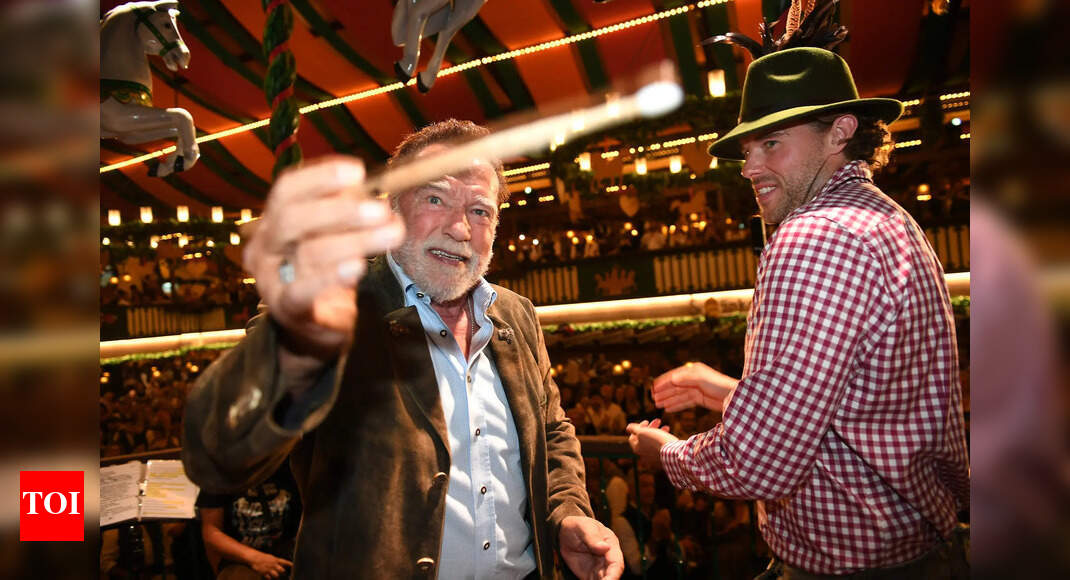 Arnold Schwarzenegger directs a band in a beer tent at Munich's Oktoberfest - WATCH