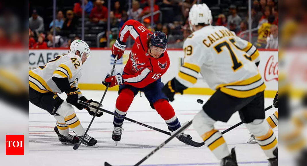 Sonny Milano of the Washington Capitals attempts an audacious net-front lacrosse goal against the Boston Bruins
