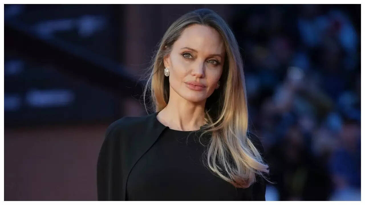 Angelina Jolie shows off back tattoo in backless dress at 'Couture'  premiere - PICS | - The Times of India