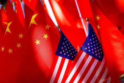 FILE - American flags are displayed with Chinese flags in Beijing. (AP Photo/Andy Wong, File) How a single 'technical rule' change by America angered China, leading to escalation in US-China trade tensions