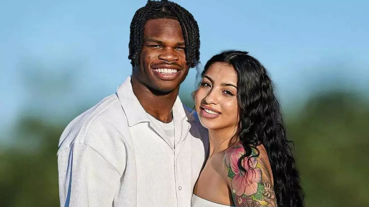 Travis Hunter and wife Leanna share adorable family moment in matching black gymwear with newborn son