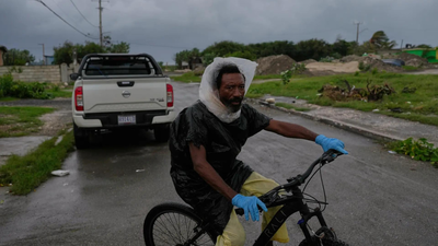 A man rides a bicycle ahead of the forecast arrival of Hurricane Melissa in Kingston, Jamaica (AP image)   Hurricane Melissa nears Jamaica risking 1.5 million people; PM orders evacuations