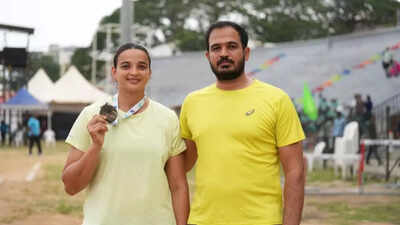 Seema Kaliramna with her coach Balancing motherhood & PhD, discus thrower Seema dreaming of LA glory