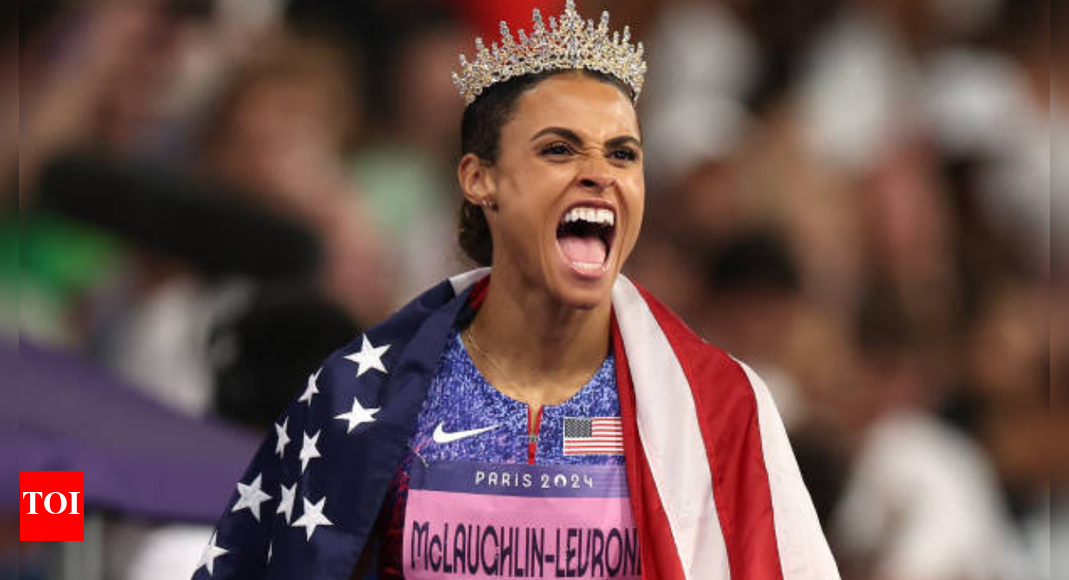 Sydney McLaughlin-Levrone in her New Balance running gear, captured mid-stride during a 400m hurdles competition.