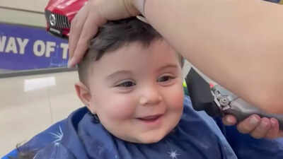 This toddler’s constant smile during a haircut is pure joy, and it will melt your heart