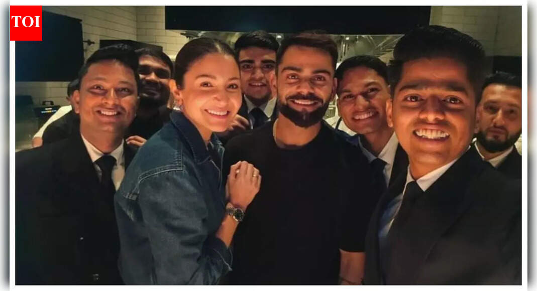 Virat-Anushka are all smiles as they pose with hotel staff- Pics