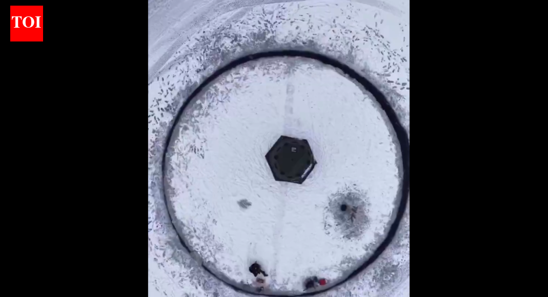 Crafting ice: Man cuts a giant circular sheet of snow and makes it spin like a wheel