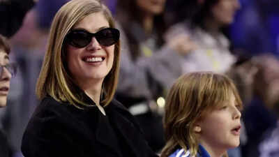 Hollywood star Rosamund Pike makes rare NBA courtside appearance with son Atom in London