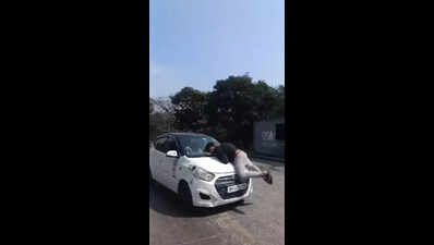 Woman drives cabby for 2km on car bonnet after he tries to stop her following accident