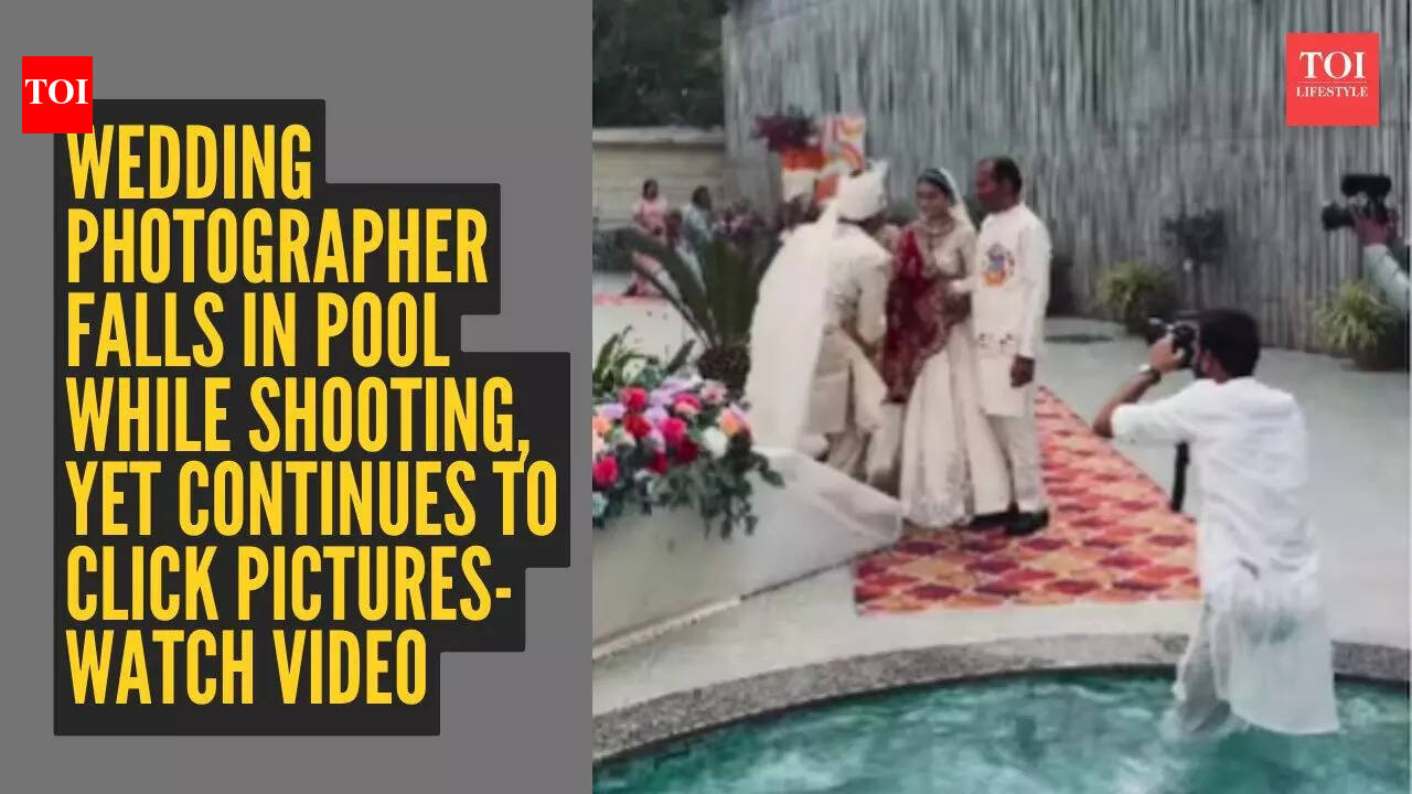 Watch: Wedding photographer falls into pool mid-shoot - but still doesn’t stop clicking pictures