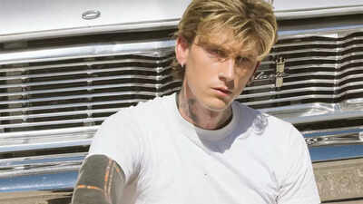 Machine Gun Kelly shows off new ear tattoos at Clive Davis Grammys party