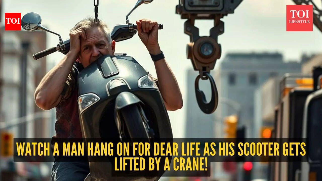 Caught on camera: Man clings to his scooter mid-air while towing crane doesn’t stop! |