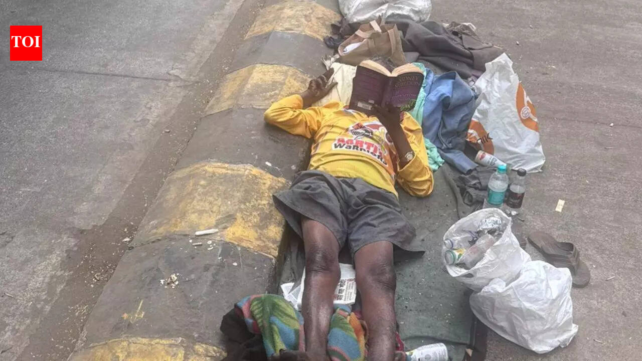 A beggar was spotted enjoying an English novel while lying on the footpath in a viral post: Who is he?