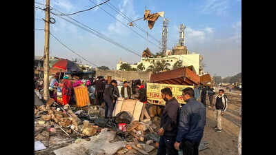 Families living in tents evicted, protestors climb atop water tank