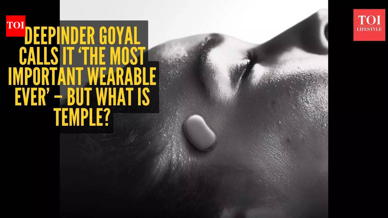 Close-up shot of the compact, silver 'Temple' wearable device positioned near a person's temple.