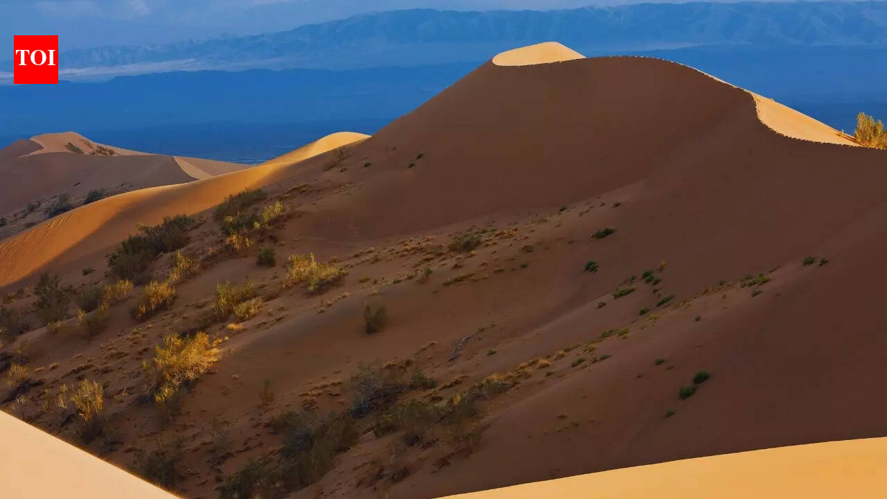 What is the mystery behind the Singing Dunes of Kazakhstan?