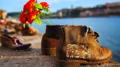 Why are dozens of shoes lying abandoned along the Danube?  Who do they belong to?