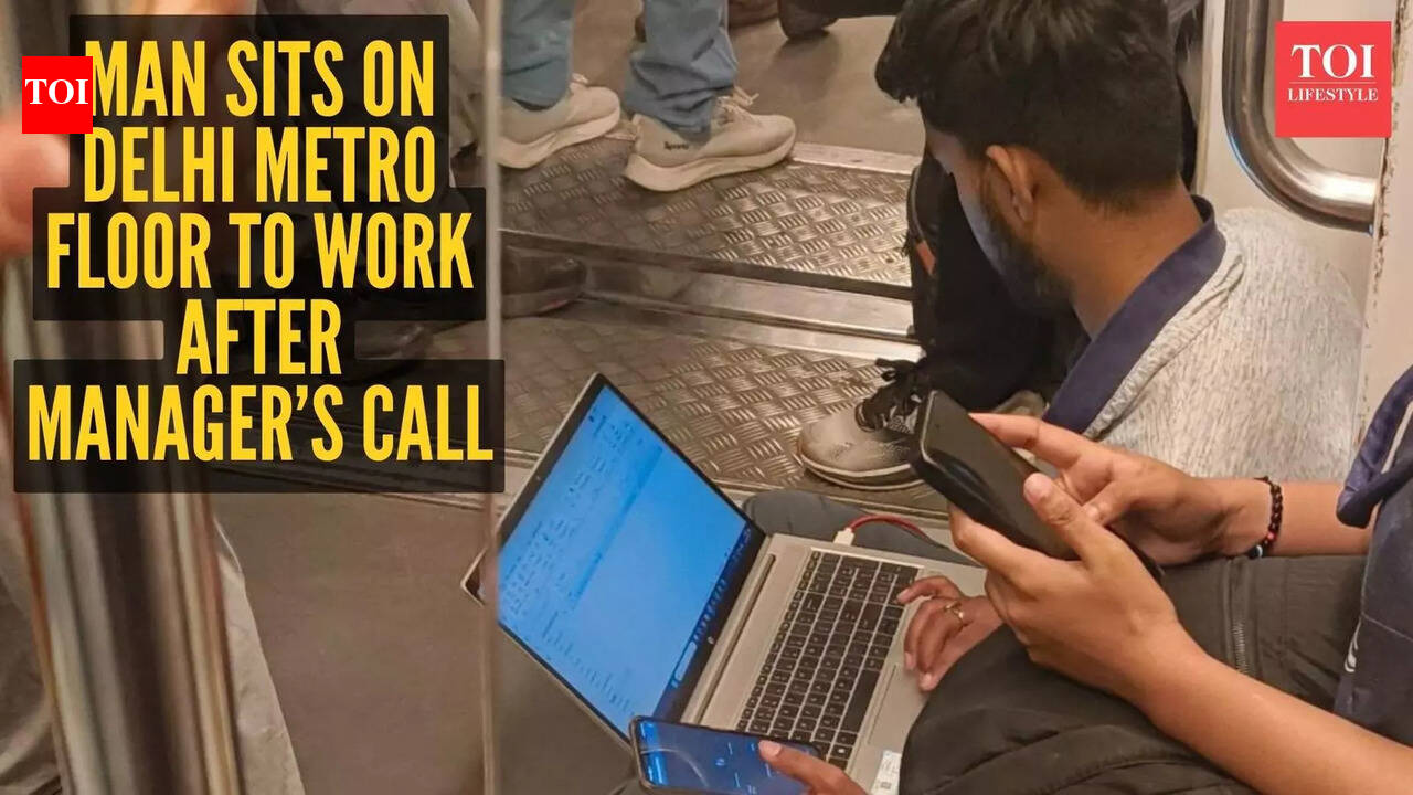 Man sits on Delhi Metro floor to work after manager’s call; viral photo sparks toxic work culture debate